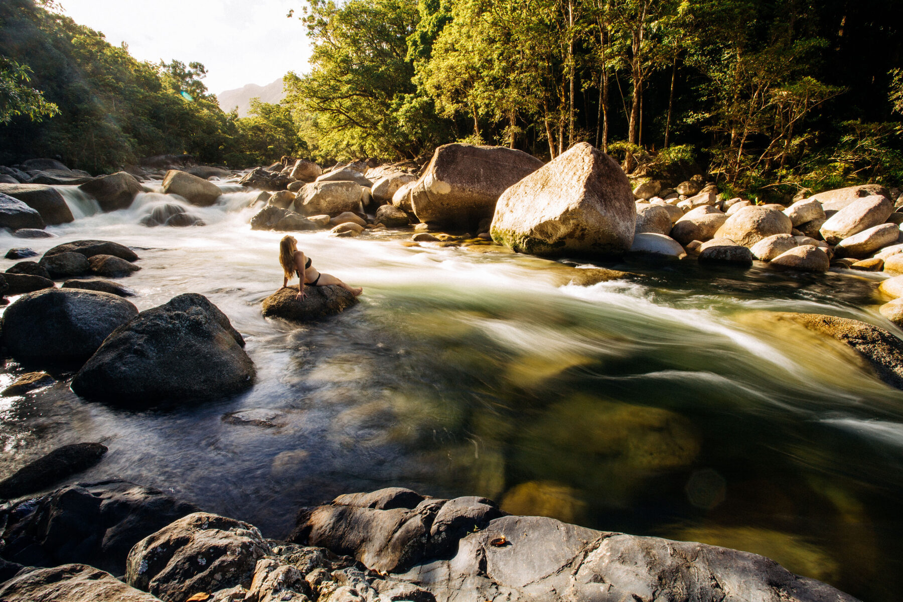 mossman-gorge-daintree-rainforest-girl-on-rock-watching-rapids